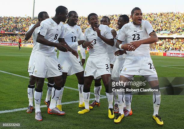 Asamoah Gyan of Ghana celebrates scoring a penalty with team mates during the 2010 FIFA World Cup South Africa Group D match between Ghana and...