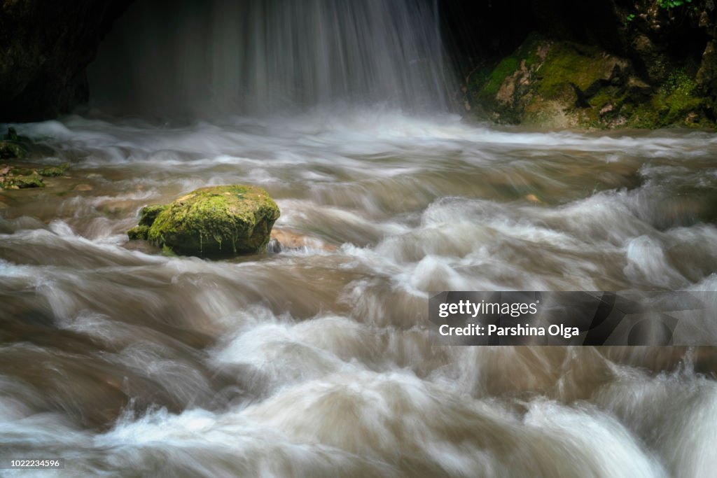 Stone lie on the coastline of waterfall. Caucasus region, Russia