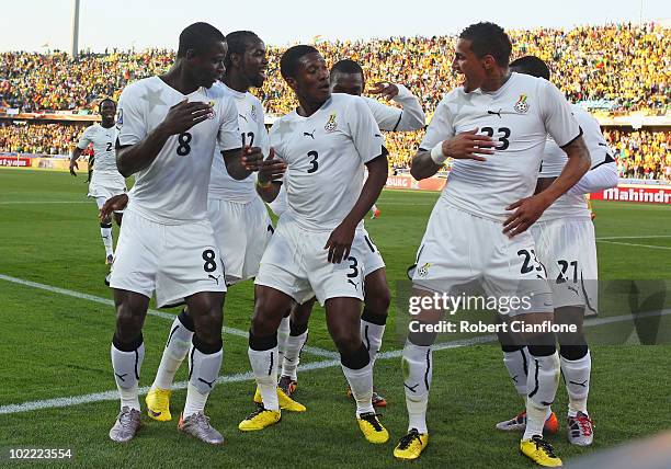 Asamoah Gyan of Ghana celebrates scoring a penalty with team mates during the 2010 FIFA World Cup South Africa Group D match between Ghana and...