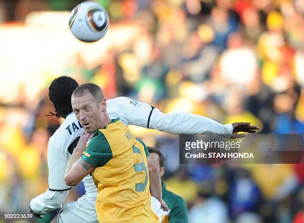 Australia's defender Craig Moore fights for the ball with Ghana's striker Prince Tagoe during the Group D first round 2010 World Cup football match...
