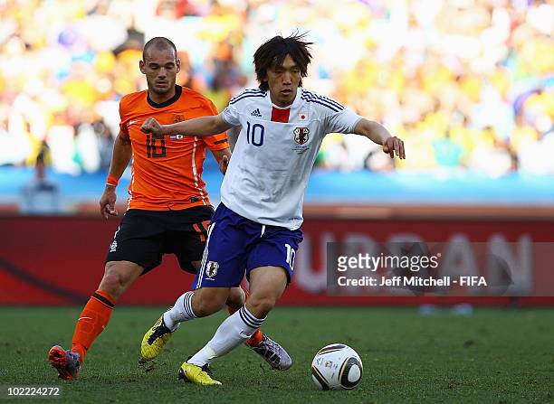 Shunsuke Nakamura of Japan is challenged by Wesley Sneijder of the Netherlands during the 2010 FIFA World Cup South Africa Group E match between...