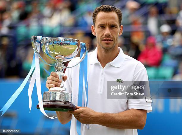 Michael Llodra of France celebrates with the trophy after winning the Final against Guillermo Garcia-Lopez of Spain during day six of the AEGON...