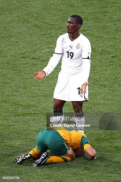 Lee Addy of Ghana appeals after tackling Craig Moore of Australia during the 2010 FIFA World Cup South Africa Group D match between Ghana and...