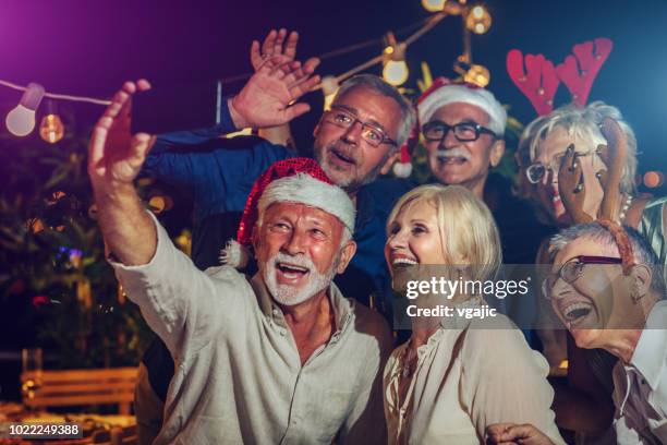 senior new year rooftop party - 70 year male stock pictures, royalty-free photos & images