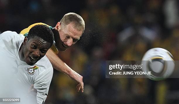 Australia's defender Craig Moore heads the ball ahead of Ghana's striker Asamoah Gyan during the Group D first round 2010 World Cup football match...