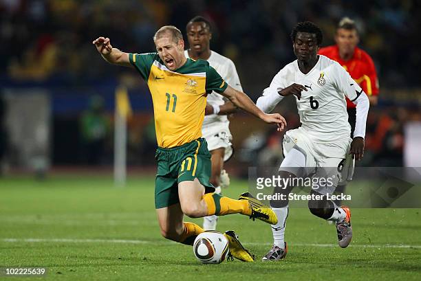 Scott Chipperfield of Australia is tripped by Anthony Annan of Ghana during the 2010 FIFA World Cup South Africa Group D match between Ghana and...