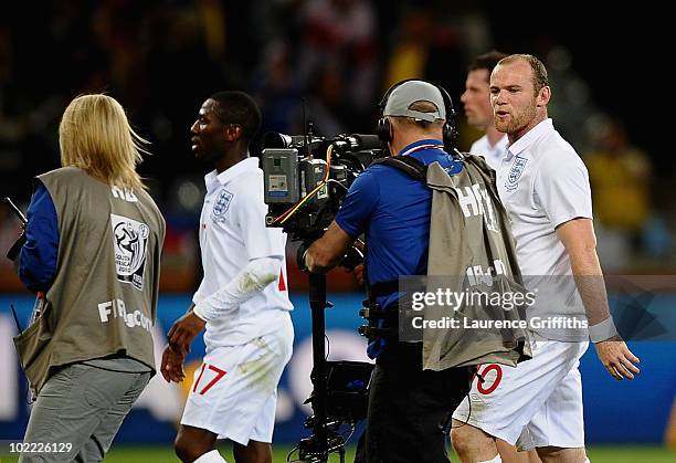 Wayne Rooney of England speaks to a cameraman as he walks off the pitch dejected after the 2010 FIFA World Cup South Africa Group C match between...