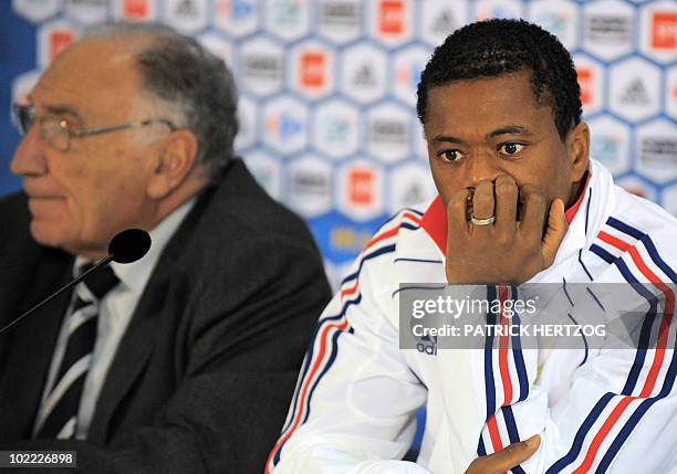 France's captain Patrice Evra reacts next to Jean-Pierre Escalettes , president of the French Football Federation, during a press conference in...