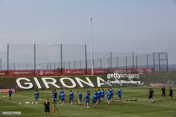 Soccer players take part in a training drill during a session at the 'La Vinya' training ground of Girona Futbol Club S.A.D., in Caldes de Malavella,...