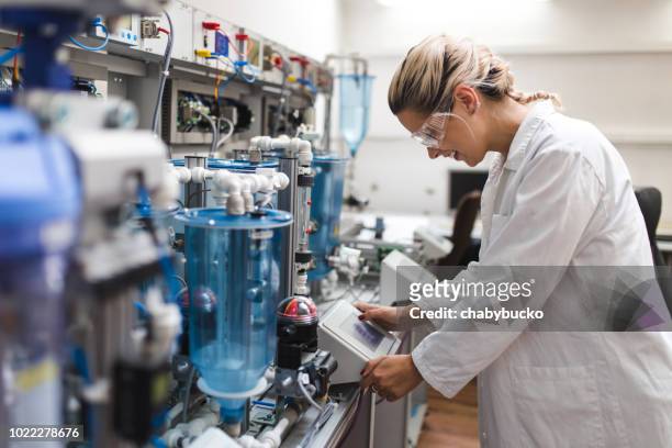 woman working in the electronic laboratory - material science stock pictures, royalty-free photos & images