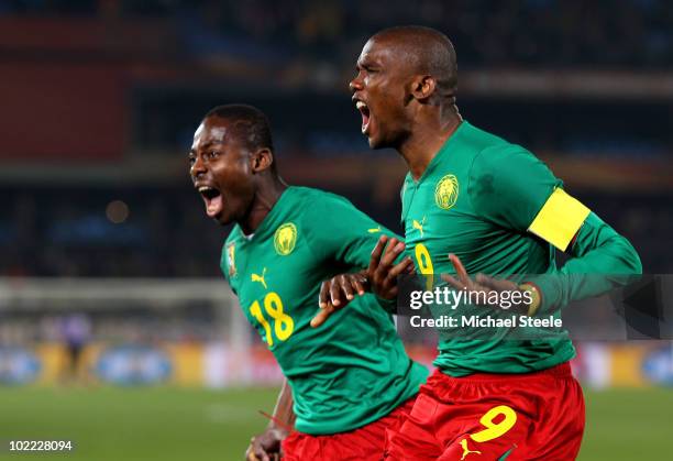 Samuel Eto'o of Cameroon celebrates scoring the first goal with team mate Eyong Enoh during the 2010 FIFA World Cup South Africa Group E match...