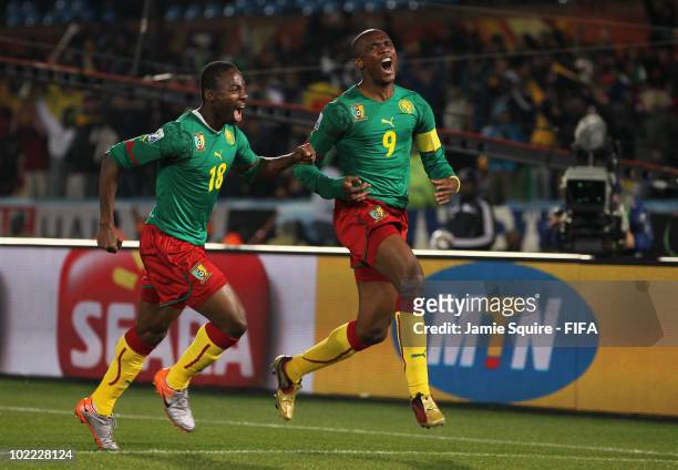 Samuel Eto'o of Cameroon celebrates with team mate Eyong Enoh after scoring the opening goal during the 2010 FIFA World Cup South Africa Group E...