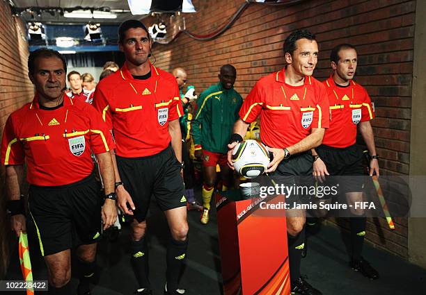 Referee Jorge Larrionda takes the matchball as he enters the pitch prior to the 2010 FIFA World Cup South Africa Group E match between Cameroon and...