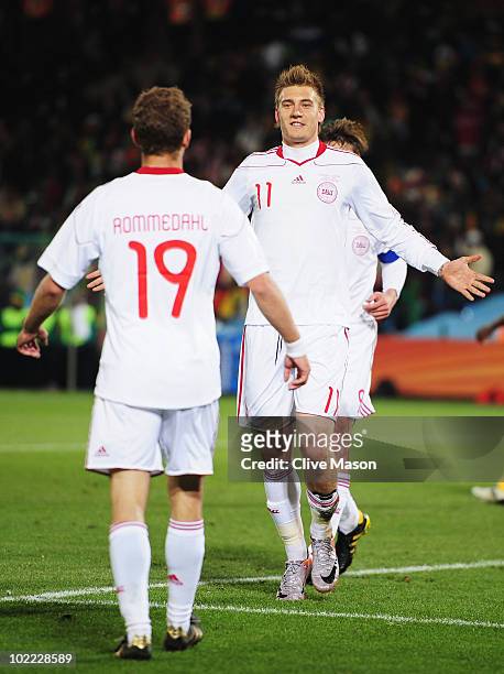 Nicklas Bendtner of Denmark celebrates scoring his team's first goal with team mate Dennis Rommedahl during the 2010 FIFA World Cup South Africa...
