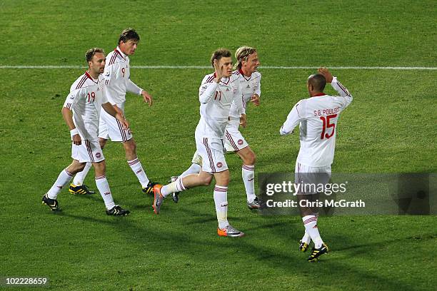 Nicklas Bendtner of Denmark celebrates scoring his team's first goal with team mates during the 2010 FIFA World Cup South Africa Group E match...