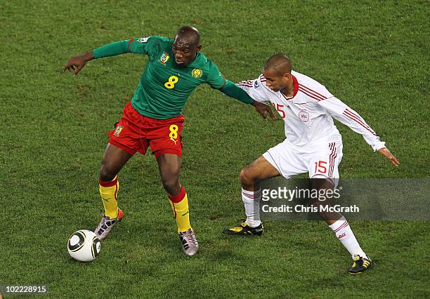 Simon Poulsen of Denmark challenges Geremi of Cameroon during the 2010 FIFA World Cup South Africa Group E match between Cameroon and Denmark at...