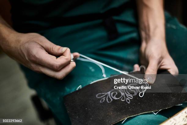 close-up of tailor in workshop making bavarian lederhosen - bayern menschen stock-fotos und bilder