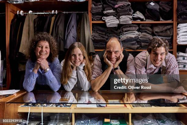 portrait of smiling family in a tailor shop - mother with daughters 12 16 stock pictures, royalty-free photos & images