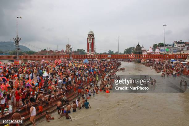 Hindu Lord Shiva devotees 'kanwadiyas' arrive to offer prayers and collect holy water during the holy month of 'Shravan' from river Ganga, in...
