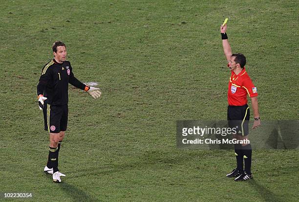 Thomas Sorensen of Denmark reacts as he is shown a yellow card by referee Jorge Larrionda in the 2010 FIFA World Cup South Africa Group E match...