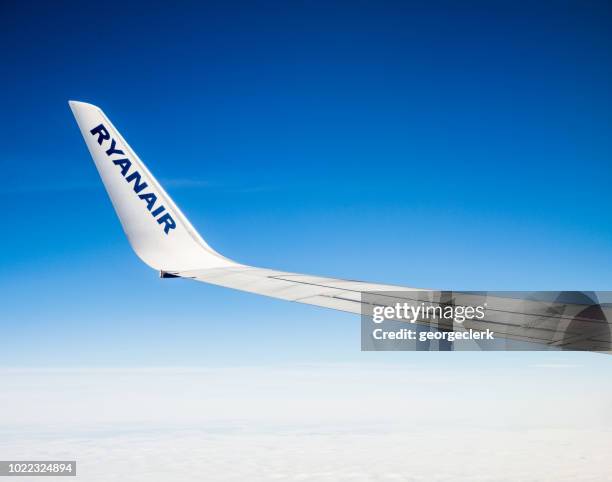 mid air - ryanair branding on a plane's wing tip - ryanair stock pictures, royalty-free photos & images