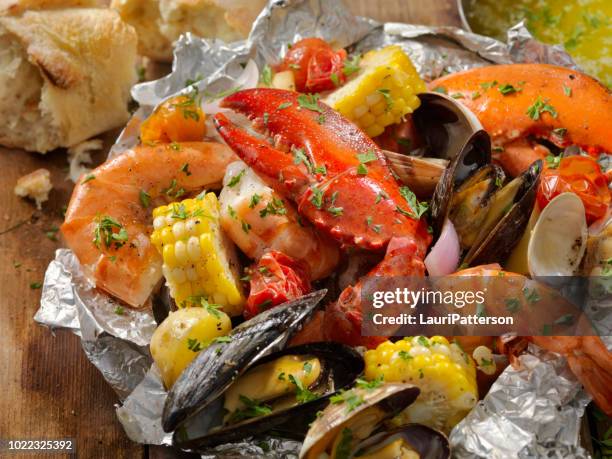 tin foil wrapped shellfish - lobster seafood stock pictures, royalty-free photos & images