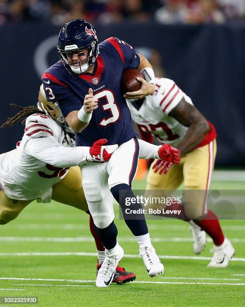Brandon Weeden of the Houston Texans is tackled by Sheldon Day of the San Francisco 49ers as he rushes with the ball in the second half during a...