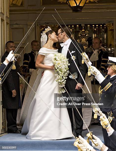 Crown Princess Victoria of Sweden, Duchess of Vastergotland and her husband Prince Daniel of Sweden, Duke of Vastergotland kiss as they leave...