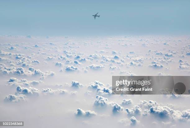 passenger jet flying above cloud field. - clouds turbulence fotografías e imágenes de stock