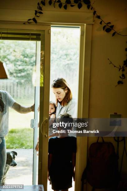 family coming into house from backyard - baby arrival stock pictures, royalty-free photos & images