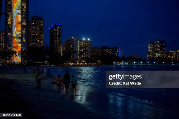 The threat of Hurricane Lane does not deter New York visitors, Leo Wahl mom, Valerie Wahl and Ian Walh from strolling along the ocean near the Hilton...