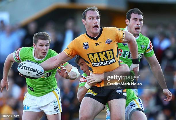 Gareth Ellis of the Tigers looks to offload during the round 15 NRL match between the Wests Tigers and the Canberra Raiders at Leichhardt Oval on...