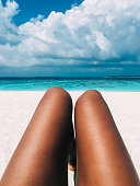 Maldives island luxury resort beach with a woman legs