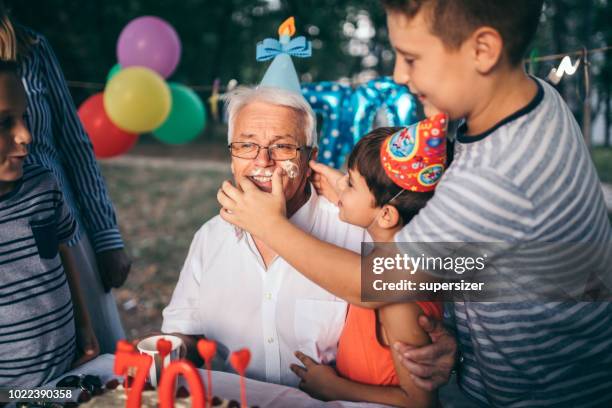 celebrating birthday with the family - food fight stock pictures, royalty-free photos & images