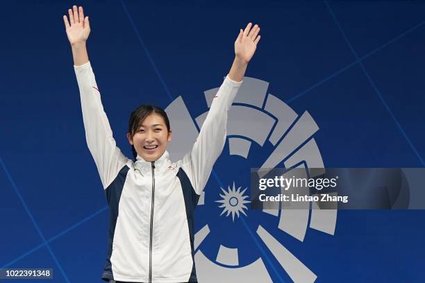 Gold medallist Japan's Rikako Ikee celebrates during the victory ceremony for the womens 50m freestyle swimming event on day six of the Asian Games...