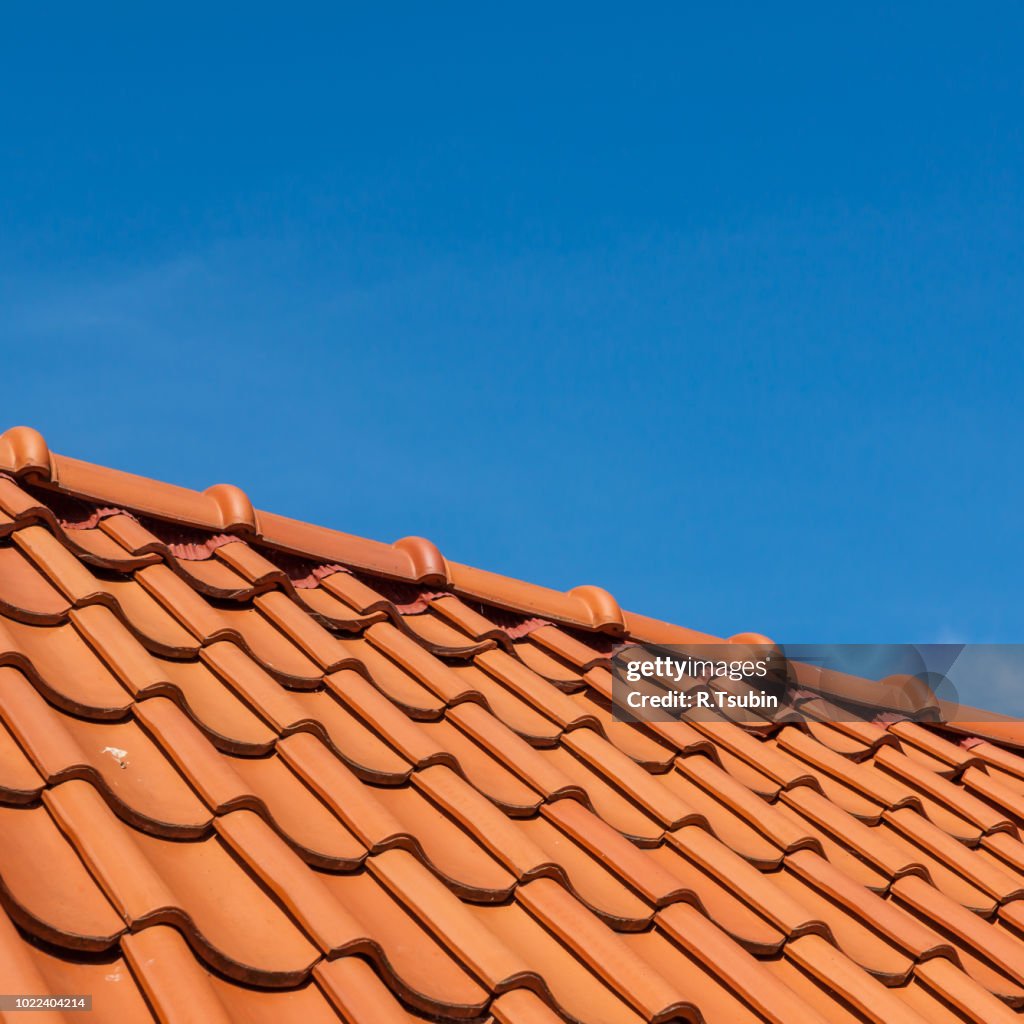 Roof tile pattern, close up. Over blue sky