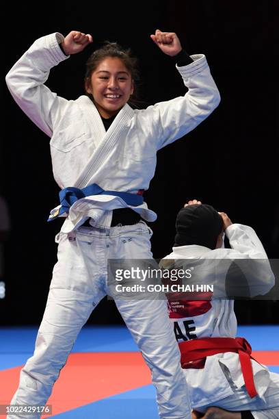 Jessa Khan of Cambodia celebrates after beating Mahra Alhinaai of United Arab Emirates in the jujitsu newaza women's under 49kg finals during the...