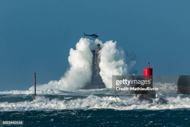 man vs wild : the helicopter in the storm vs a huge wave - finistere stock pictures, royalty-free photos & images