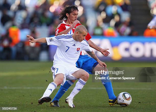 Vladimir Weiss of Slovakia and Aureliano Torres of Paraguay battle for the ball during the 2010 FIFA World Cup South Africa Group F match between...