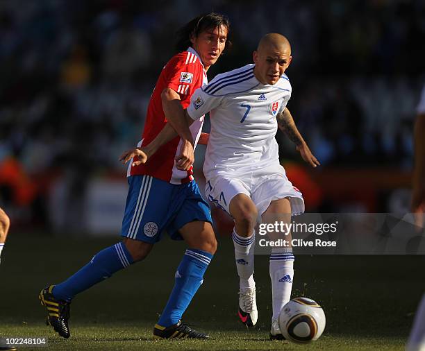 Vladimir Weiss of Slovakia is challenged by Aureliano Torres of Paraguay during the 2010 FIFA World Cup South Africa Group F match between Slovakia...