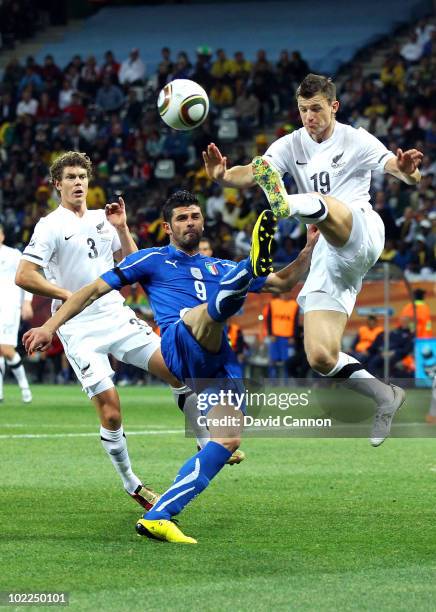 Vincenzo Iaquinta of Italy is tackled by Tommy Smith of New Zealand during the 2010 FIFA World Cup South Africa Group F match between Italy and New...