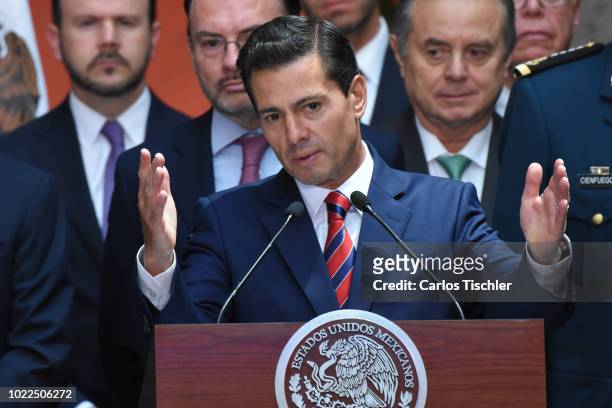 President of Mexico Enrique Peña Nieto speaks during a press conference at Palacio Nacional on August 20, 2018 in Mexico City, Mexico. Obrador met...