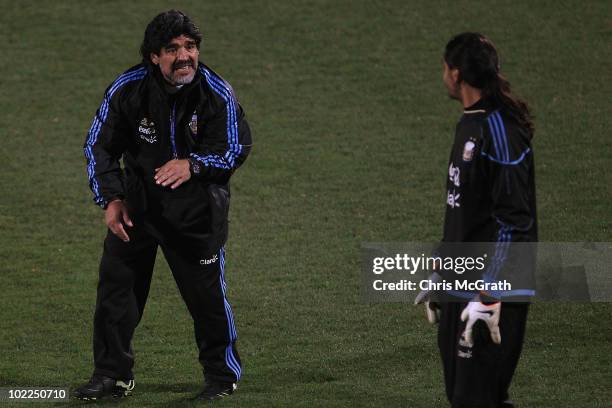 Argentina's head coach Diego Maradona gives advice to goalkeeper Sergio Romero during a team training session on June 20, 2010 in Pretoria, South...