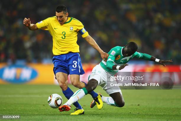 Lucio of Brazil and Ismael Tiote of Ivory Coast battle for the ball during the 2010 FIFA World Cup South Africa Group G match between Brazil and...