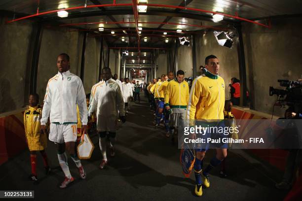 Didier Drogba of Ivory Coast and Lucio of Brazil lead their teams through the tunnel prior to the 2010 FIFA World Cup South Africa Group G match...