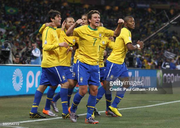 Elano of Brazil celebrates with team mates after scoring the third goal during the 2010 FIFA World Cup South Africa Group G match between Brazil and...