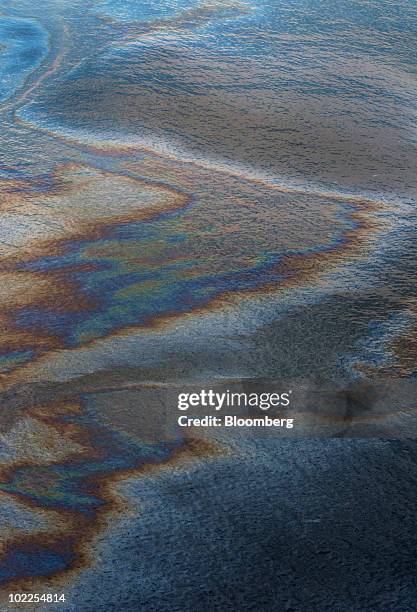 Sheen of oil floats on the surface of the Gulf of Mexico near Gulf Shores, Alabama, U.S., on Saturday, June 19, 2010. The BP Plc oil spill, which...