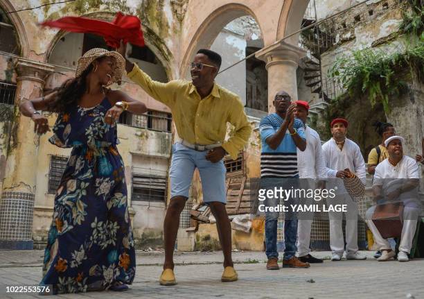 Cubans dance Rumba in a street of Havana, on August 22, 2018. - The Rumba, a mix of African and Spanish culture, considered by UNESCO an Intangible...
