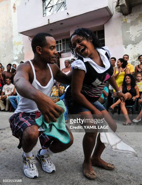 Couple dance Rumba in a street of Havana, on August 22, 2018. - The Rumba, a mix of African and Spanish culture, considered by UNESCO an Intangible...