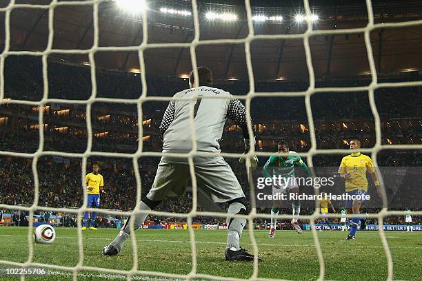 Didier Drogba of the Ivory Coast scores his side's first goal past Julio Cesar of Brazil during the 2010 FIFA World Cup South Africa Group G match...